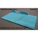 Cobblestones street with stone wall